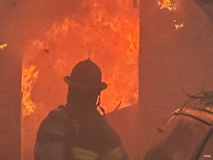 Firefighter with flames in background