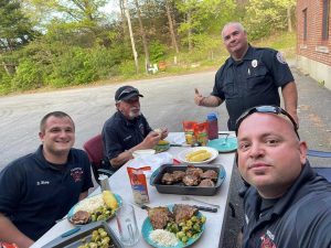 Webster firefighters enjoying a homecooked meal together