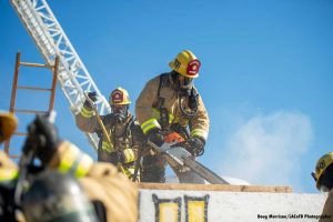 Recruit firefighters cutting prop