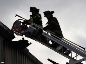 Two firefighter on aerial ladder