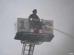 Firefighter in tower ladder bucket