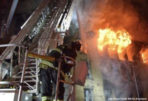 Seattle firefighter on turntable with flames in building 800 block of Madison St