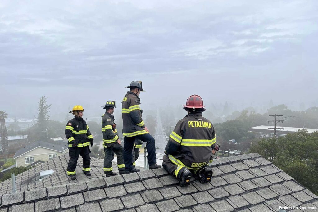 Petaluma California firefighters up on a roof