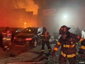 Indianapolis firefighters pull lines on the fireground